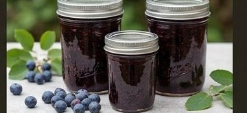 Jars of deep purple wild saskatoon berry preserves